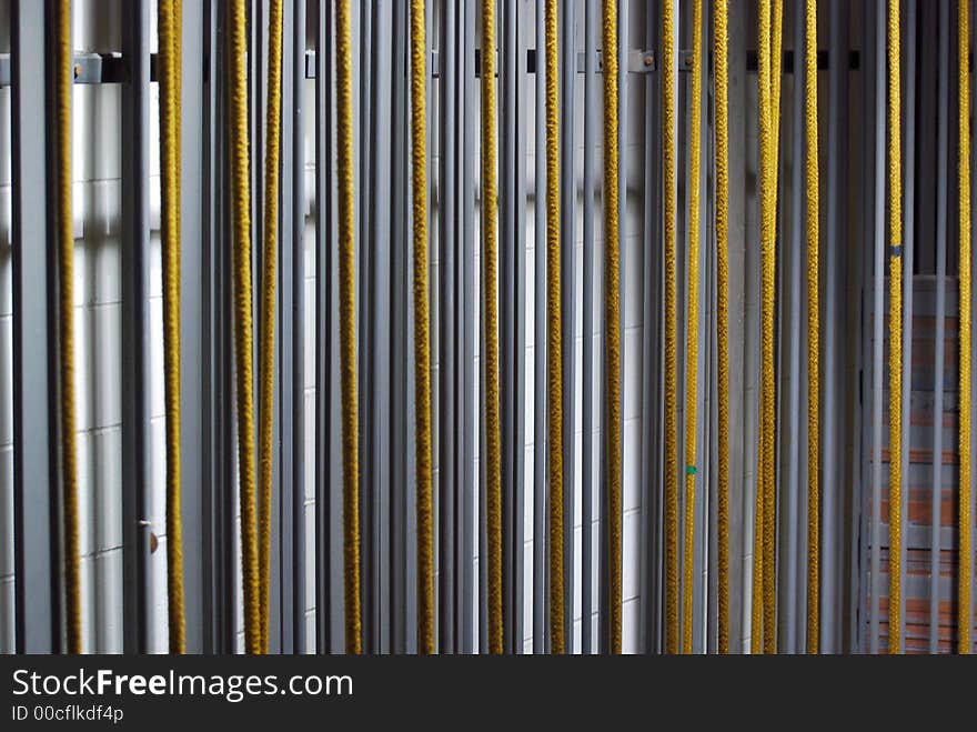 More ropes holding weights from the backstage of a theatre from a horizontal angle. More ropes holding weights from the backstage of a theatre from a horizontal angle.