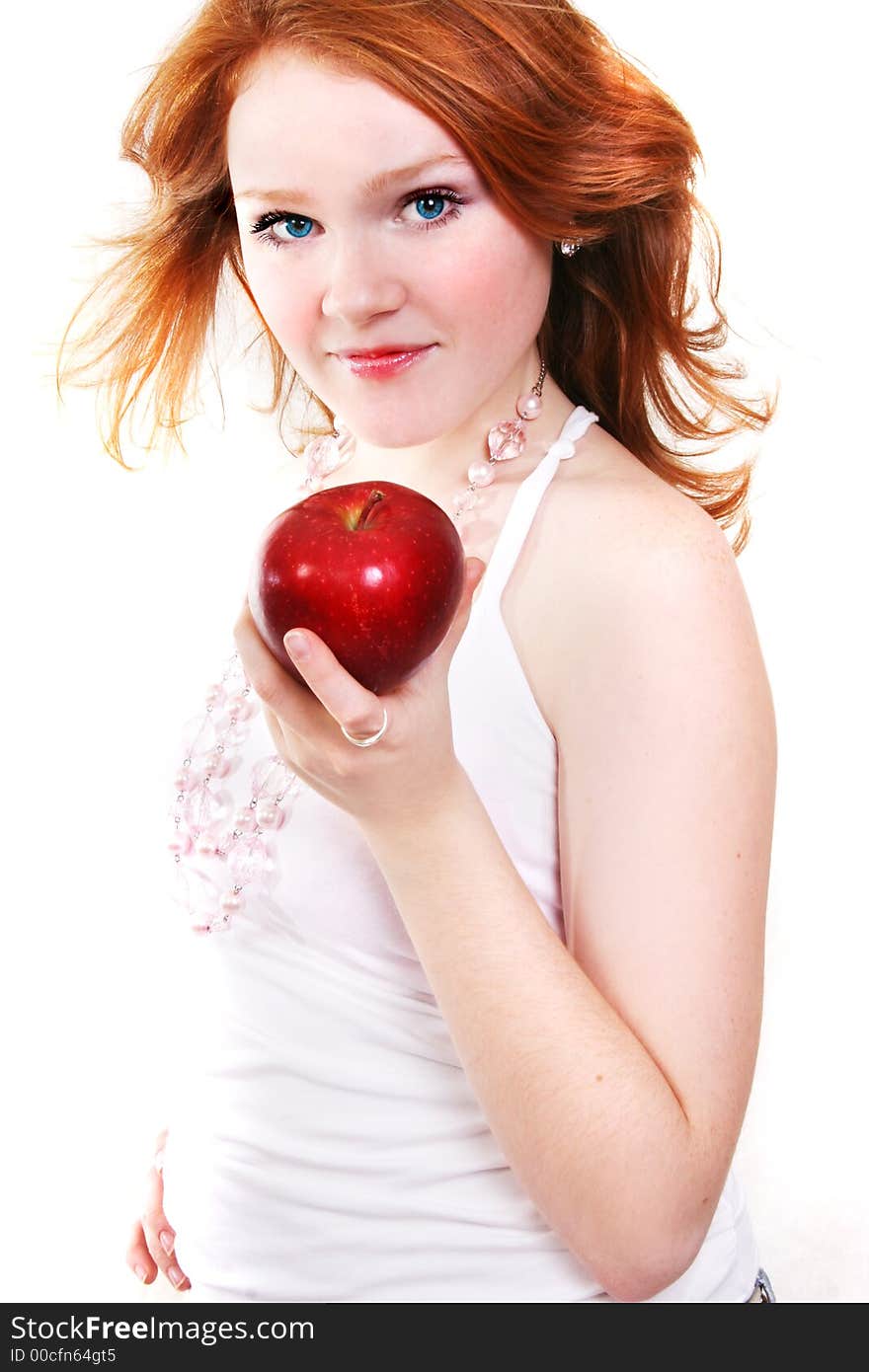 Young beautiful red smiling woman with apple on the white background. Young beautiful red smiling woman with apple on the white background