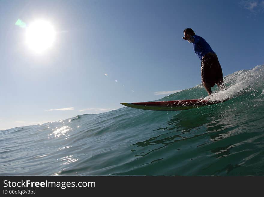 A surfer surfing down the line