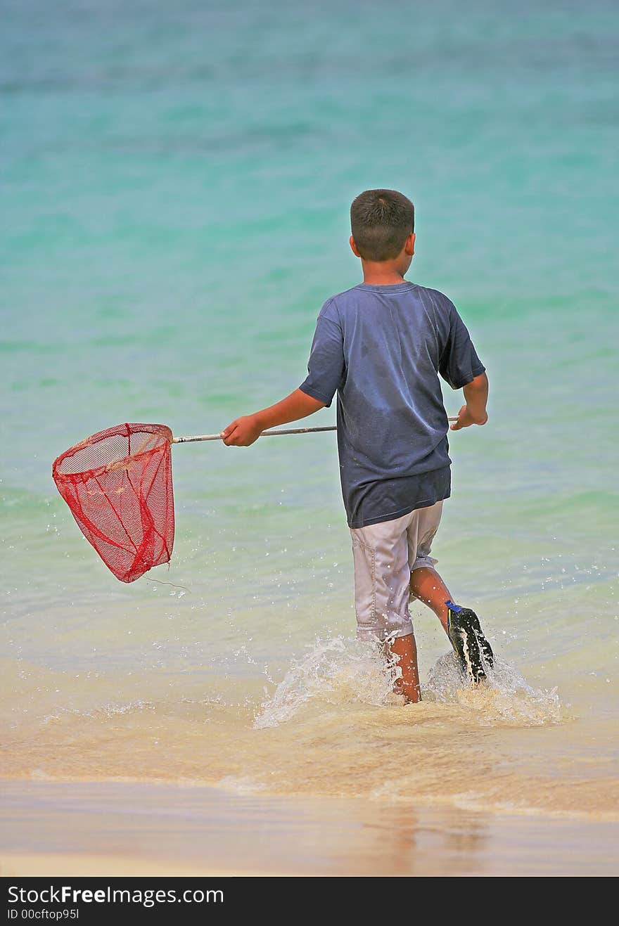 Photo of Hawaiian boy fishing at the beach. Photo of Hawaiian boy fishing at the beach