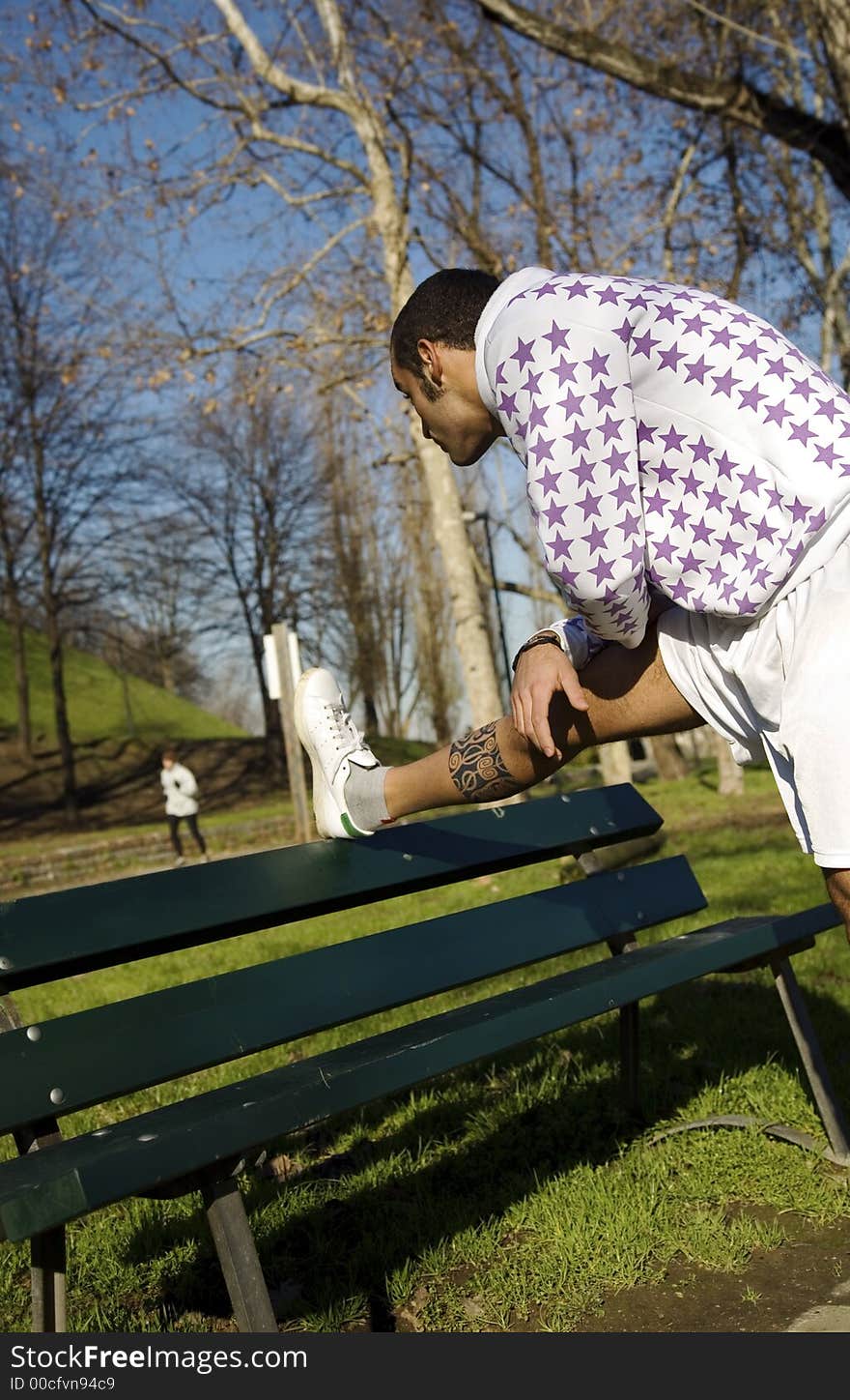 Healthy lifestyle: man doing stretching in a park. Healthy lifestyle: man doing stretching in a park