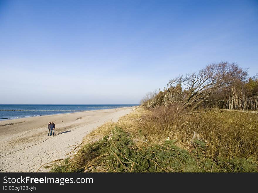 Two walkers on a beach