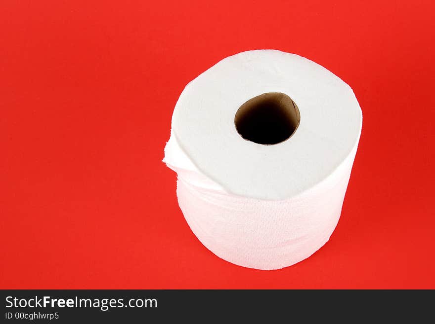 Roll of toilet paper on red background