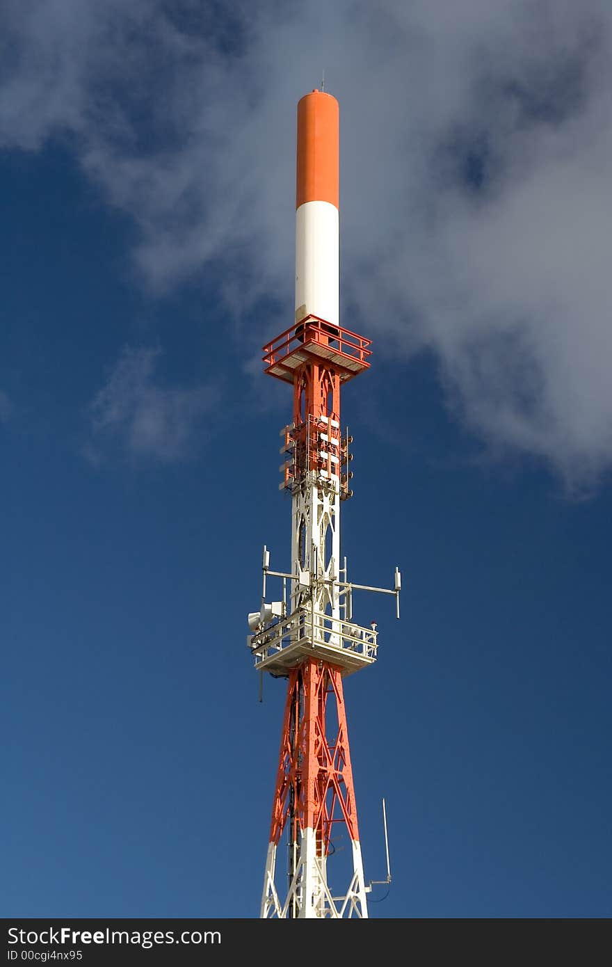 Communication tower with white clouds and blue sky as background. Communication tower with white clouds and blue sky as background