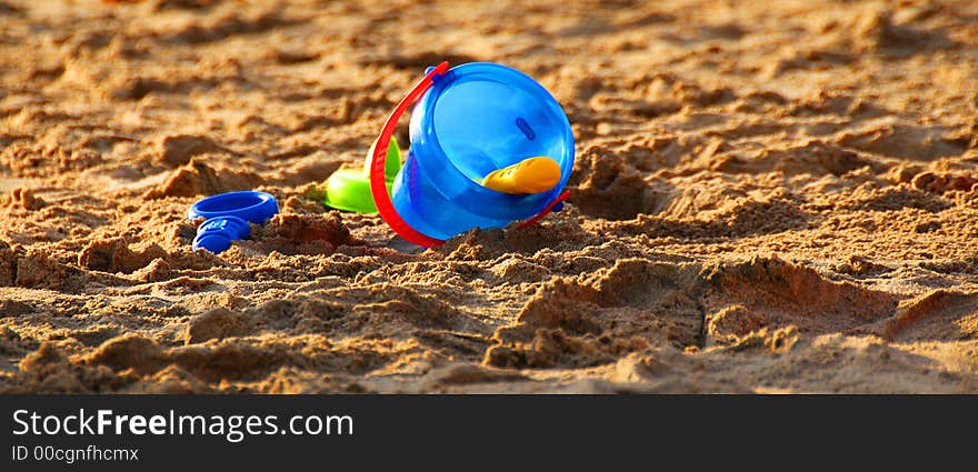 A bucket and a shavel on the sand. A bucket and a shavel on the sand