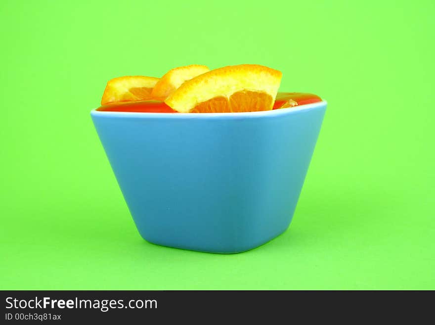 Orange Jelly in a white bowl with silverware. Orange Jelly in a white bowl with silverware.