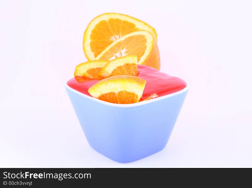 Orange Jelly in a white bowl with silverware. Orange Jelly in a white bowl with silverware.