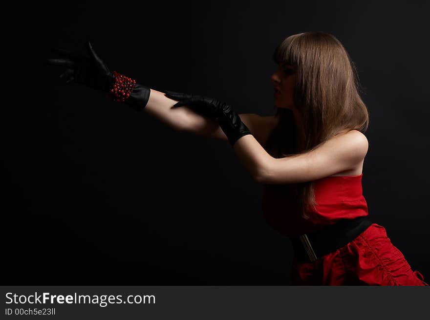 High fashion shoot - young woman over black background with moody light