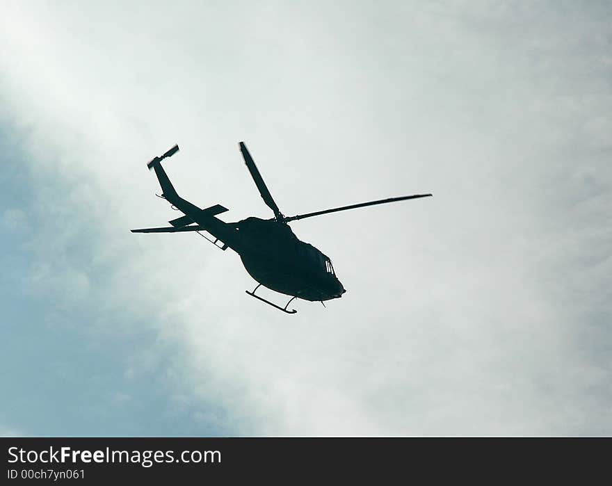 Flying Italian military chopper - back lit