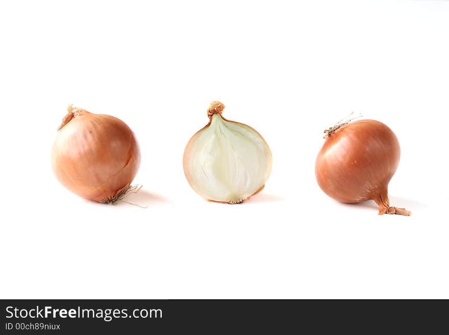 Two onions and a half on white background. Two onions and a half on white background.