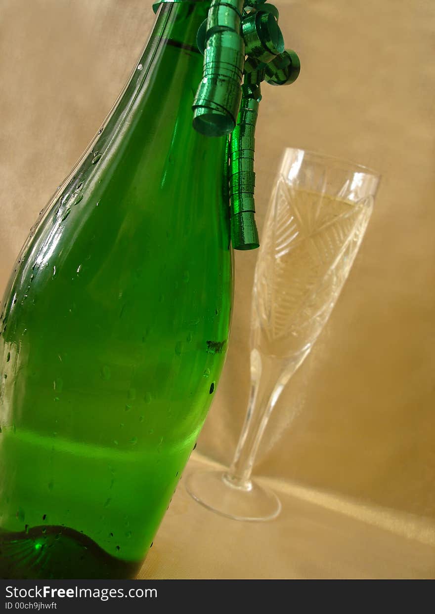 Close-up view bottle and Champagne glasses on golden background