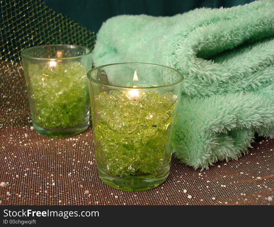 Spa essentials (green candles and towels)