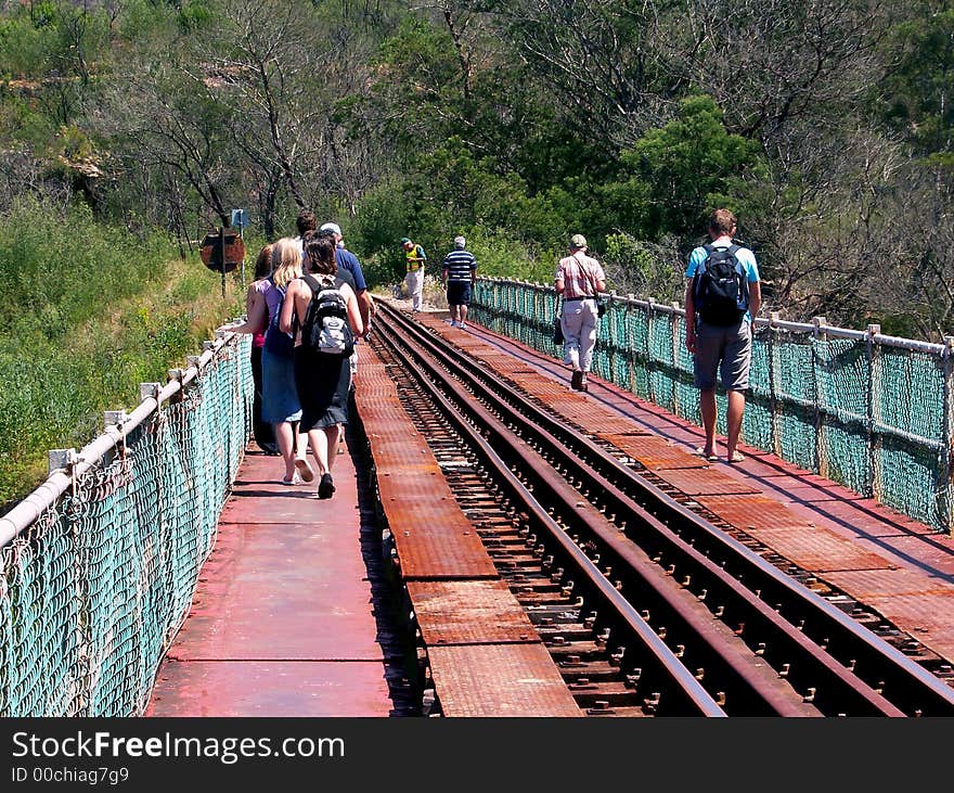 A tour group crossing an bridge. A tour group crossing an bridge