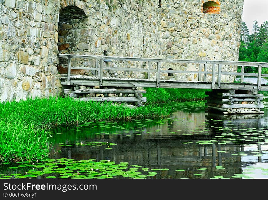 A Kronoberg stronghold in Southern Sweden. It's build on a small island surrounded by lake in all directions. The only way to it is via this wooden bridge. A Kronoberg stronghold in Southern Sweden. It's build on a small island surrounded by lake in all directions. The only way to it is via this wooden bridge.