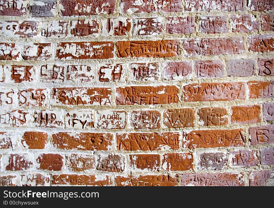 Letters carved in a bricks wall. Letters carved in a bricks wall