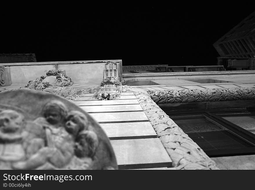 Looking up towards the top of ornate building in boston shows intricate carving of the old building with a new skyscraper and a star in the darkness of night. Looking up towards the top of ornate building in boston shows intricate carving of the old building with a new skyscraper and a star in the darkness of night