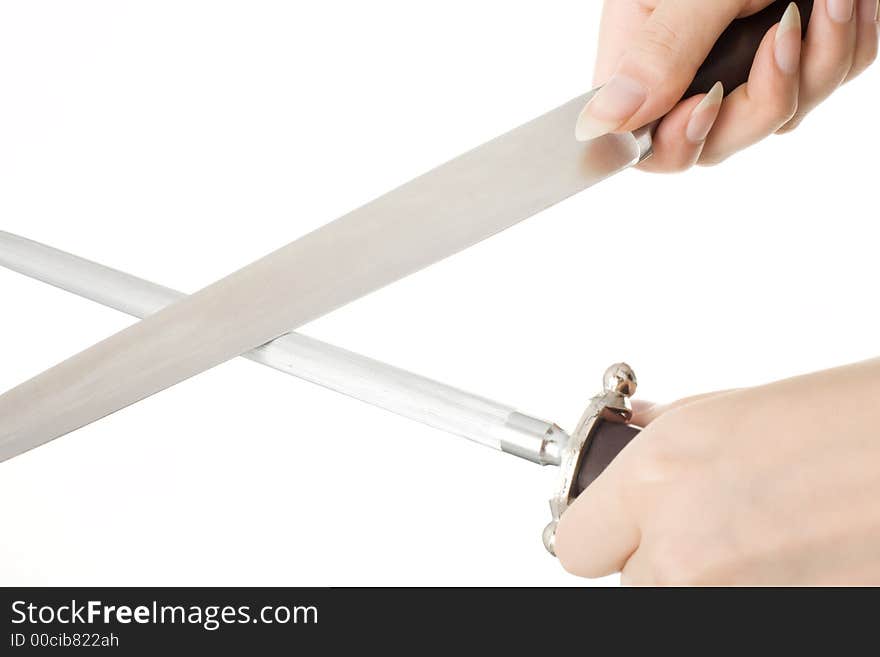 Close up of hands sharpening a carving knife