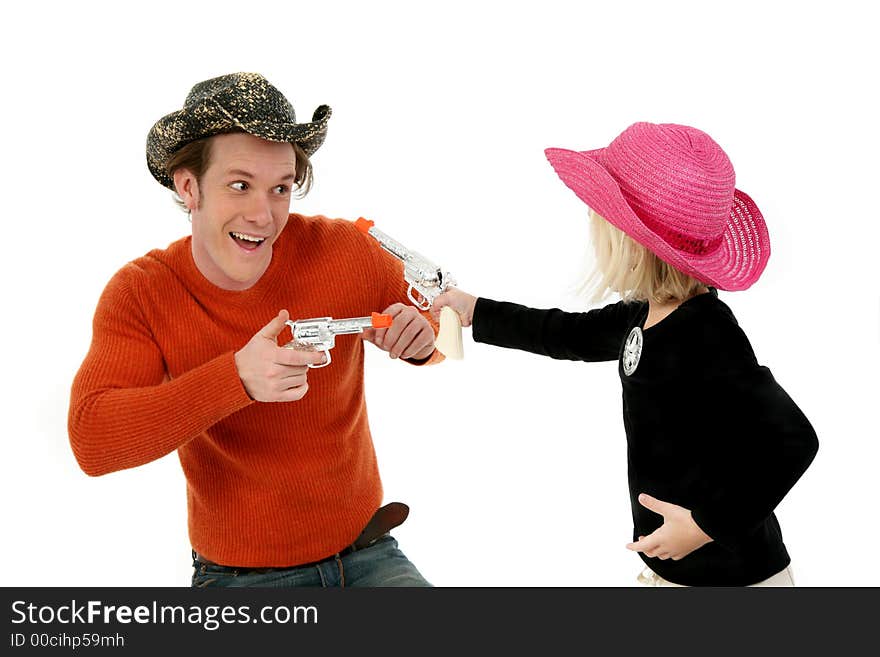 Father and five year old daughter wearing cowboy hats and laughing. Father and five year old daughter wearing cowboy hats and laughing