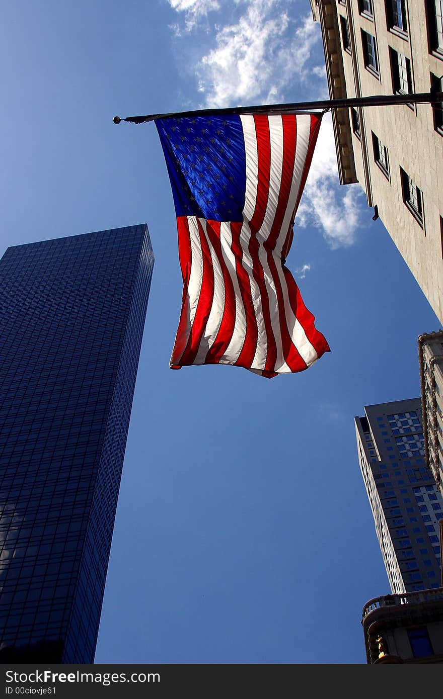 American flag and partial view of buildings in  New York City by day, United States, America. American flag and partial view of buildings in  New York City by day, United States, America