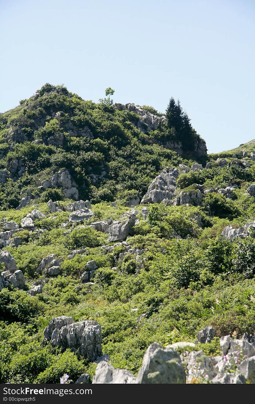 Rock, grass and sky at summer 2