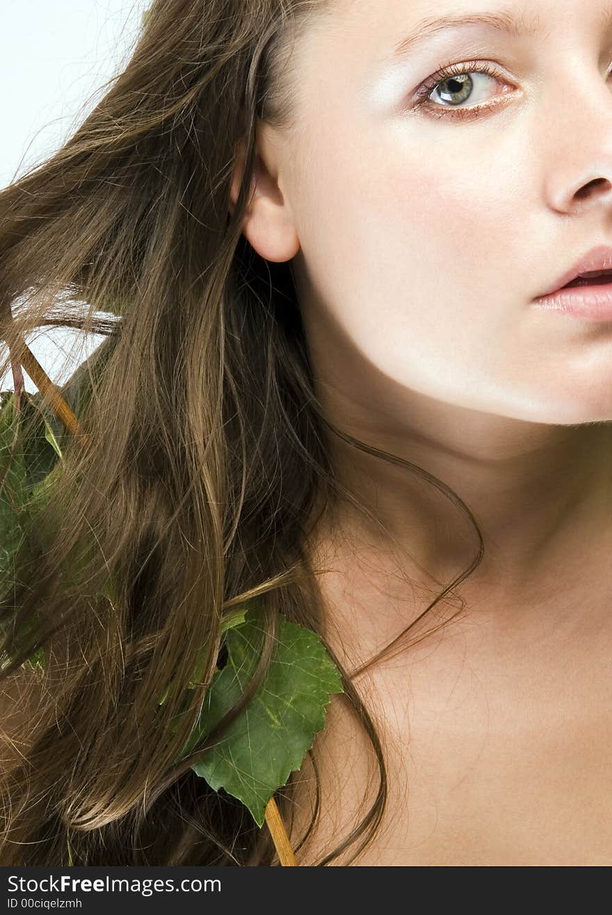 Beautiful young woman portrait with leaf