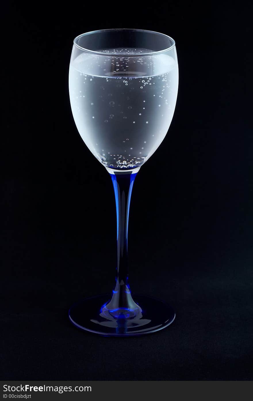 Glass with mineral water on black