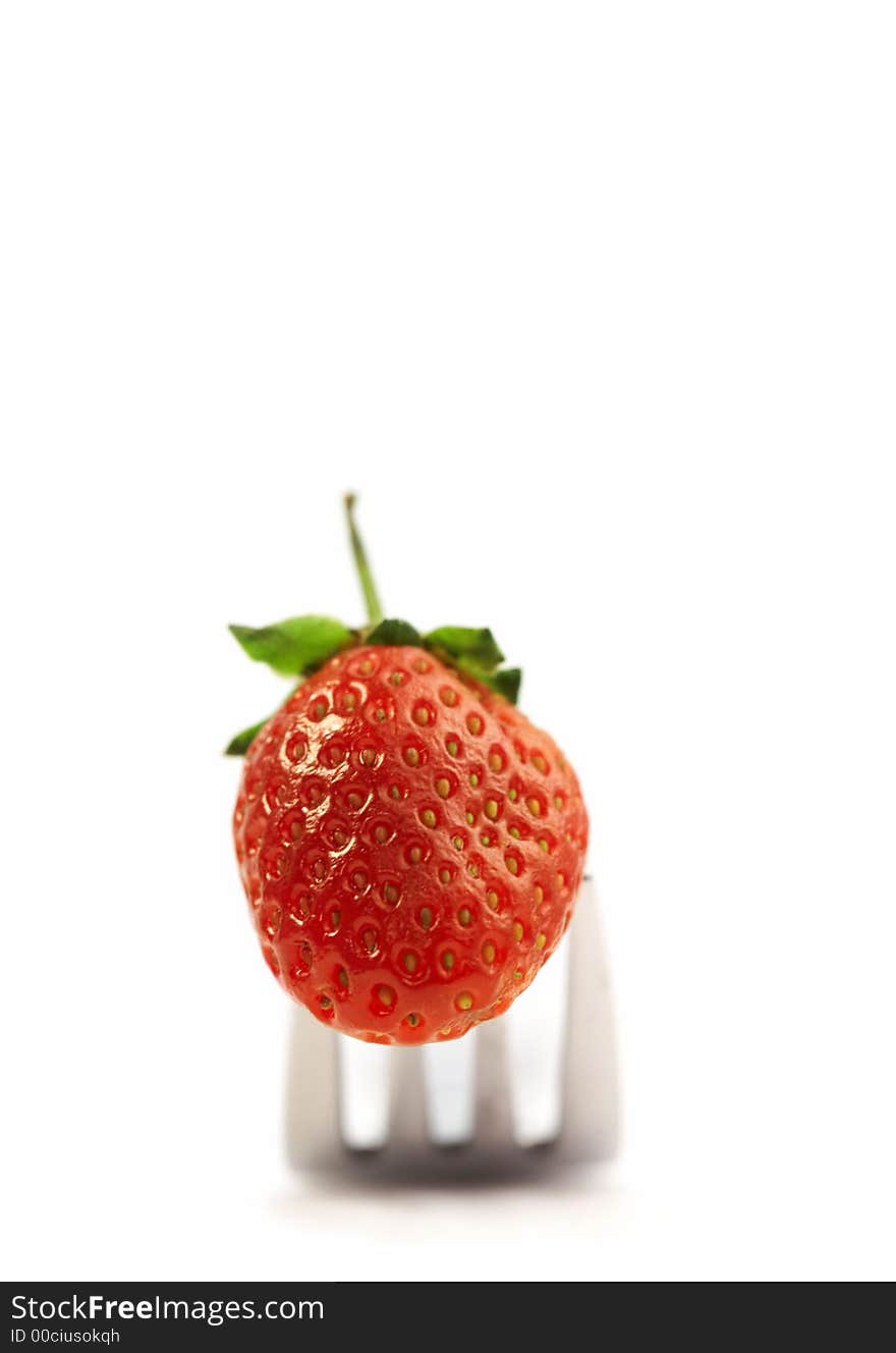 View of nice red delicious strawberry set on some fork. View of nice red delicious strawberry set on some fork