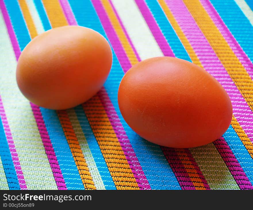 Two eggs on striped fabric