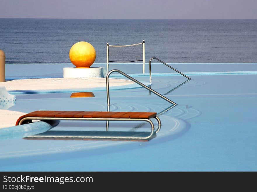 Partial view of the pools of a hotel with a yellow ball and the ocean behind in Puerto Vallarta, Jalisco, Mexico, Latin America