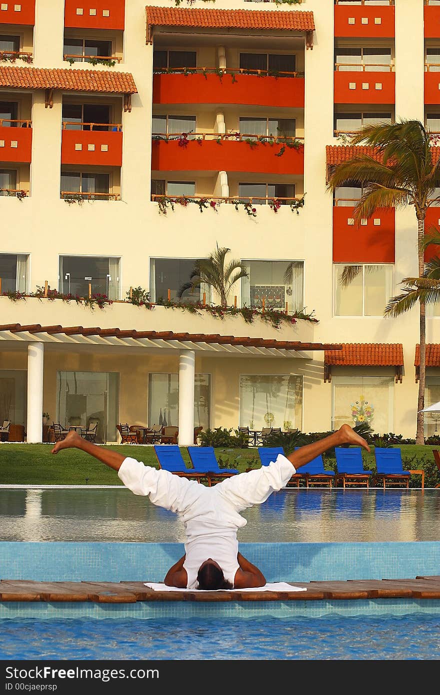 Partial view of a hotel in Puerto Vallarta with Yoga teacher on a wooden bridge between two pools, Jalisco, Mexico, Latin America