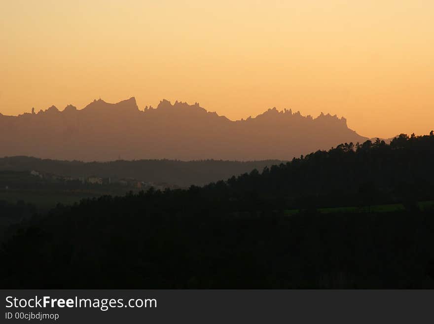 Mountain ridge near Narcelona, Spain, with red sunset sky. Mountain ridge near Narcelona, Spain, with red sunset sky