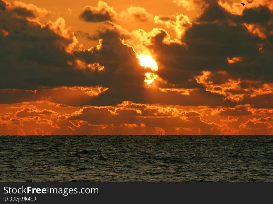 Gulf Coast sunset playing peak-a-boo with ciouds.Tampa Bay Florida