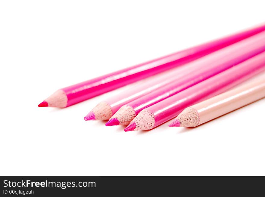 Row of spectrum of pink color pencils on a white background