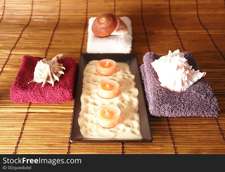 Sea shells candles towels all positioned to create health concept