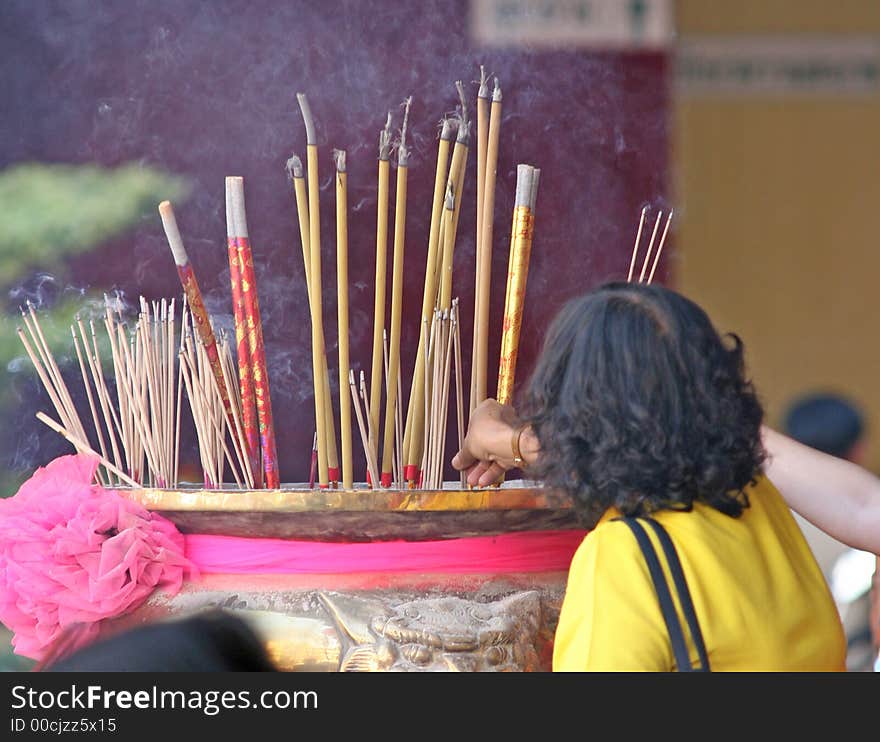 Burning incense in a temple to bring good luck during Chinese New Year