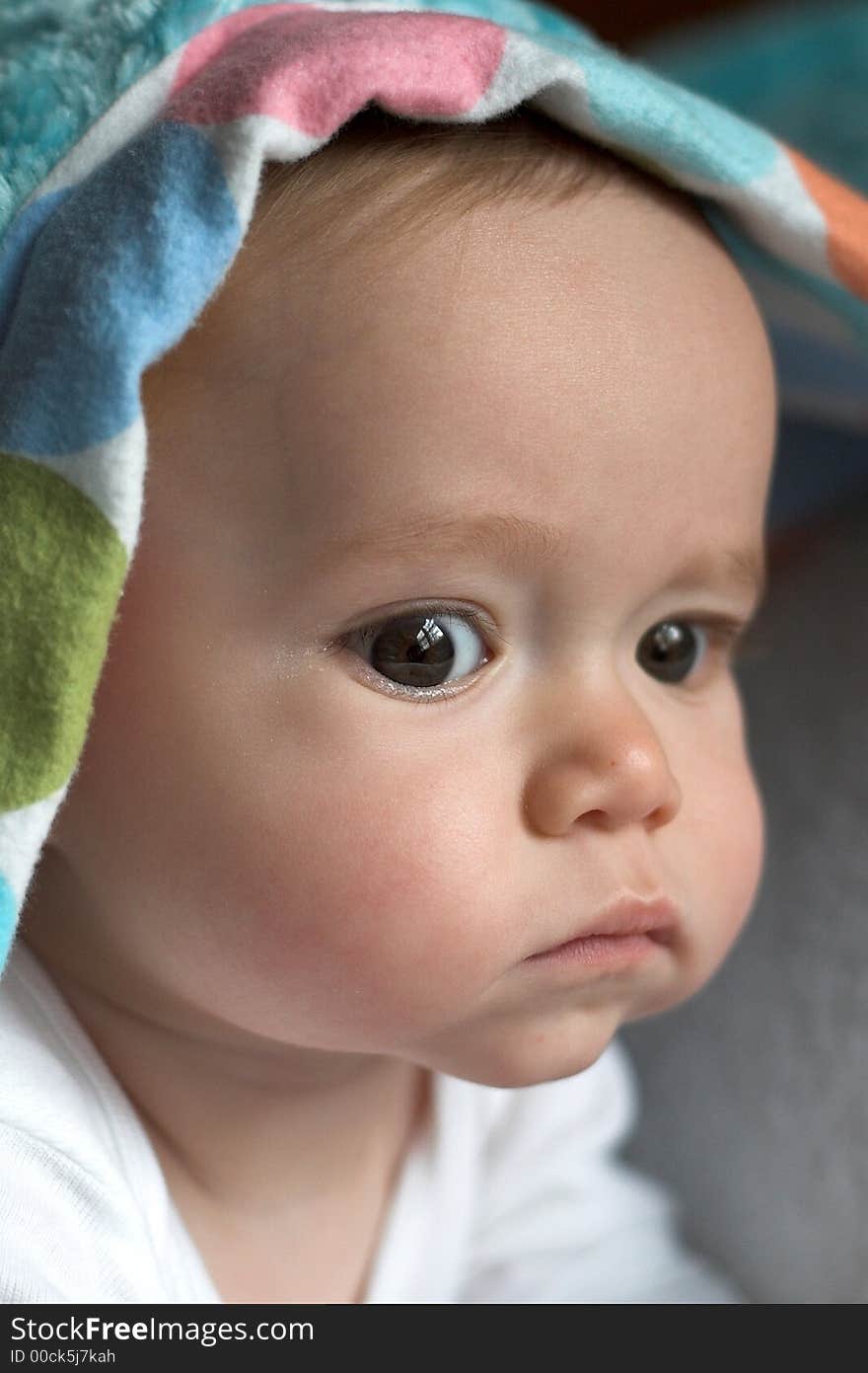 Image of baby peeking out from under a blanket. Image of baby peeking out from under a blanket