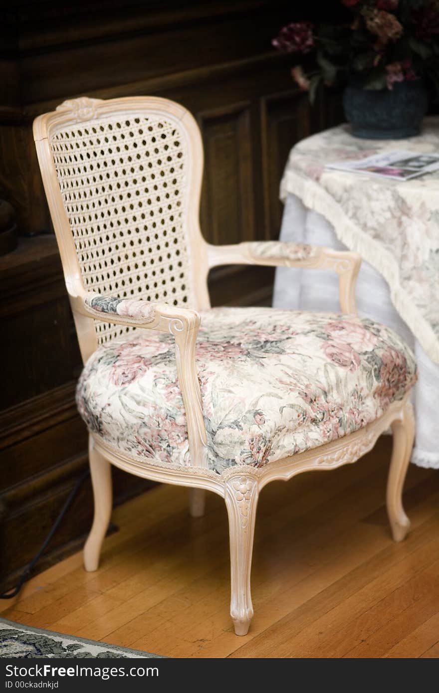 A fancy floral chair in a hotel. A fancy floral chair in a hotel