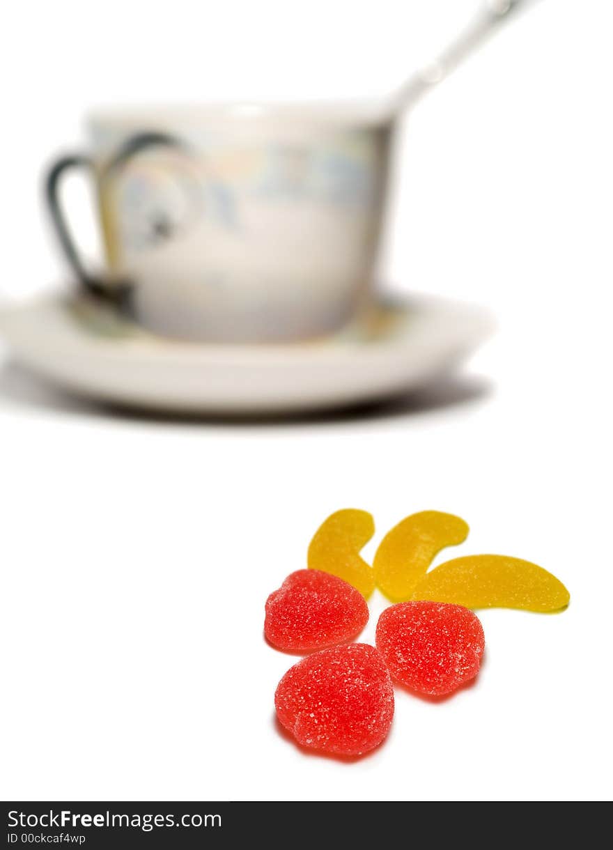 Sweets and cup isolated on white. cup is out of focus. Sweets and cup isolated on white. cup is out of focus.