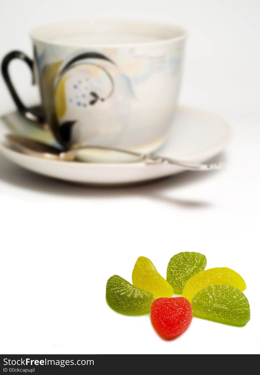 Sweets and cup isolated on white. cup is out of focus. Sweets and cup isolated on white. cup is out of focus.