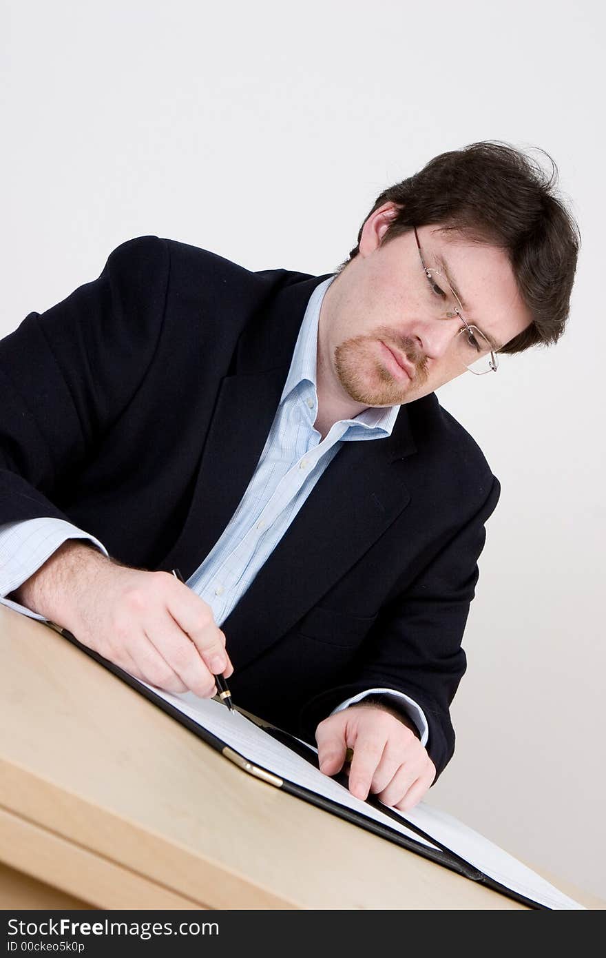 A business man in a blue suit and no tie making a decision. A business man in a blue suit and no tie making a decision