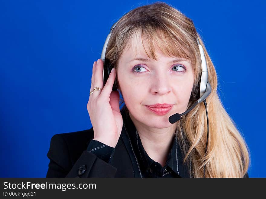 A customer representative with headset making a telephone call with a blue background