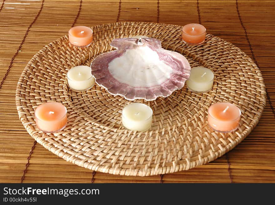 Candles in a circle with a sea shell in the middle. Candles in a circle with a sea shell in the middle