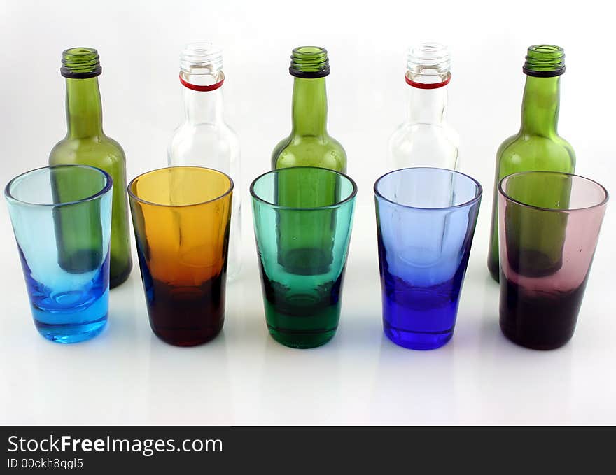 Close up of brightly colored drinking glasses and mini bottles. Close up of brightly colored drinking glasses and mini bottles