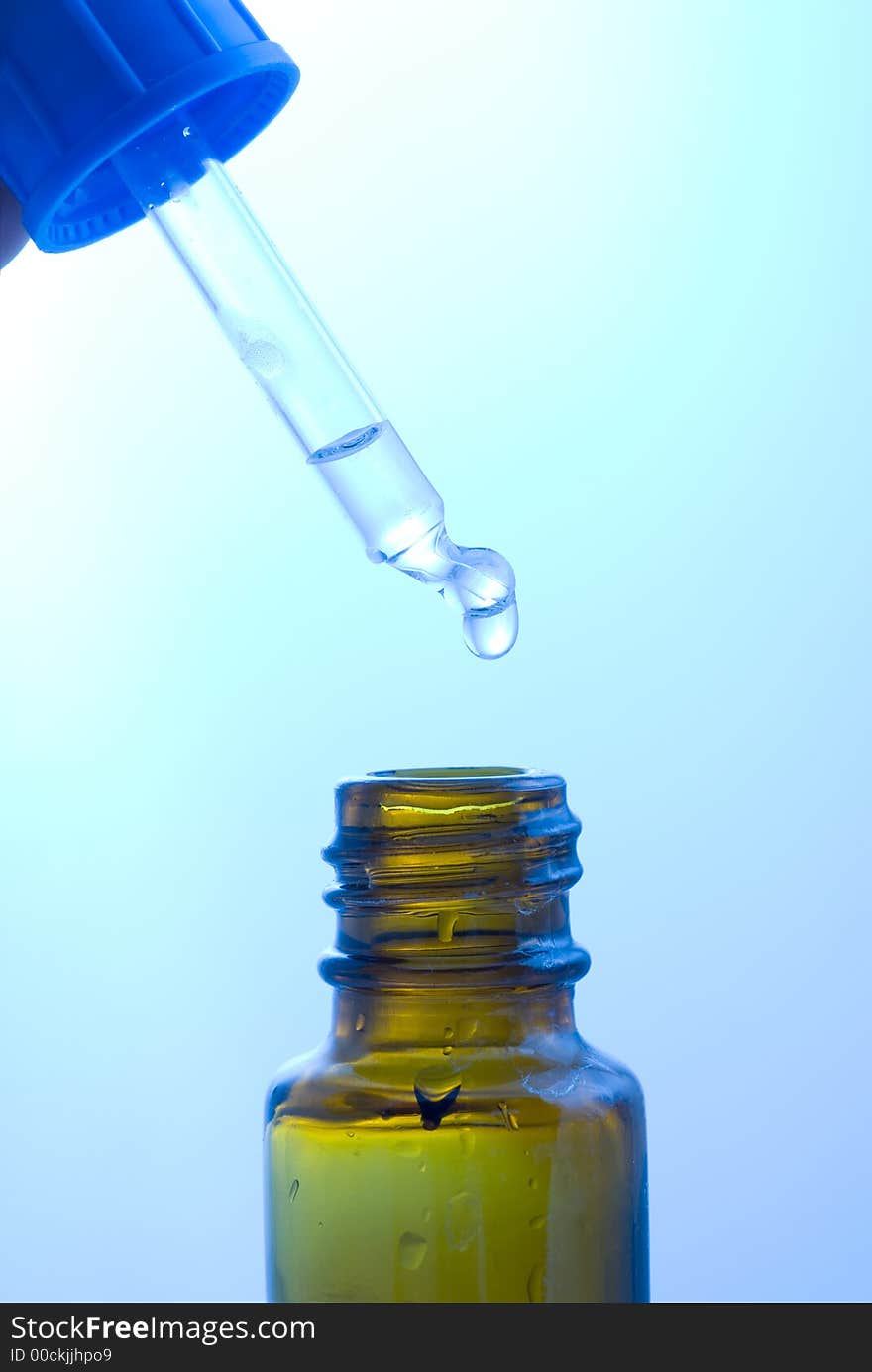 Medical dropper and a flask with transparent liquid. Medical dropper and a flask with transparent liquid