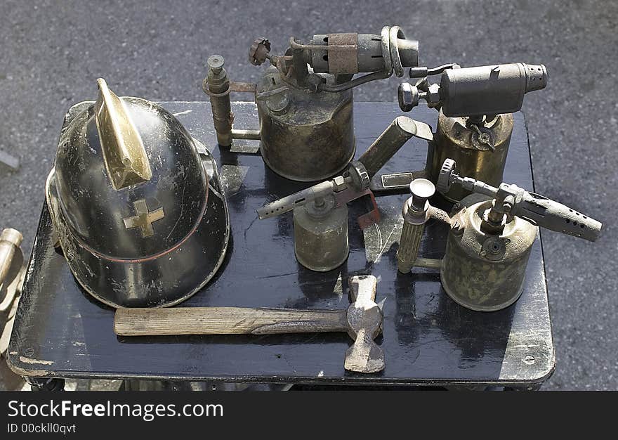 ANTIQUE MARKET. Helmet, hammer, blowtorch.