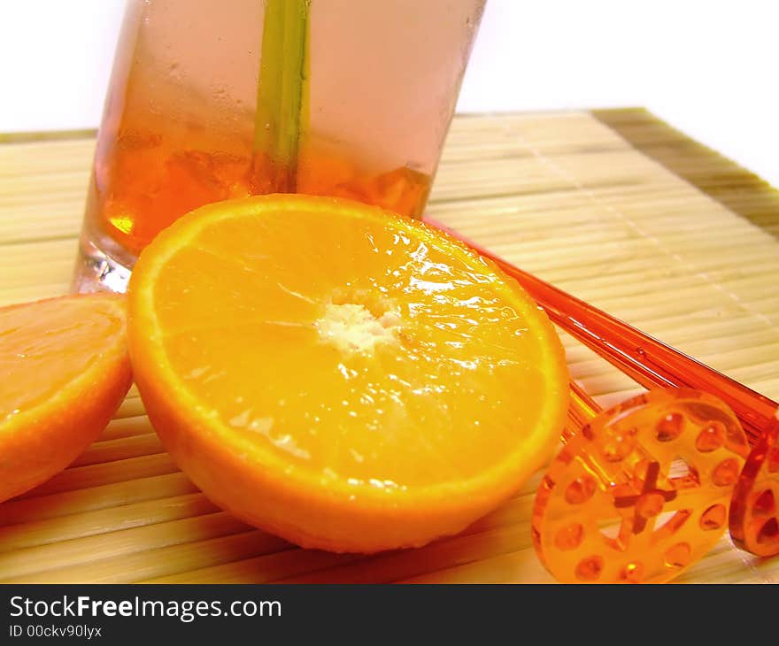 A colorful picture of oranges in front of a cocktail. A colorful picture of oranges in front of a cocktail.