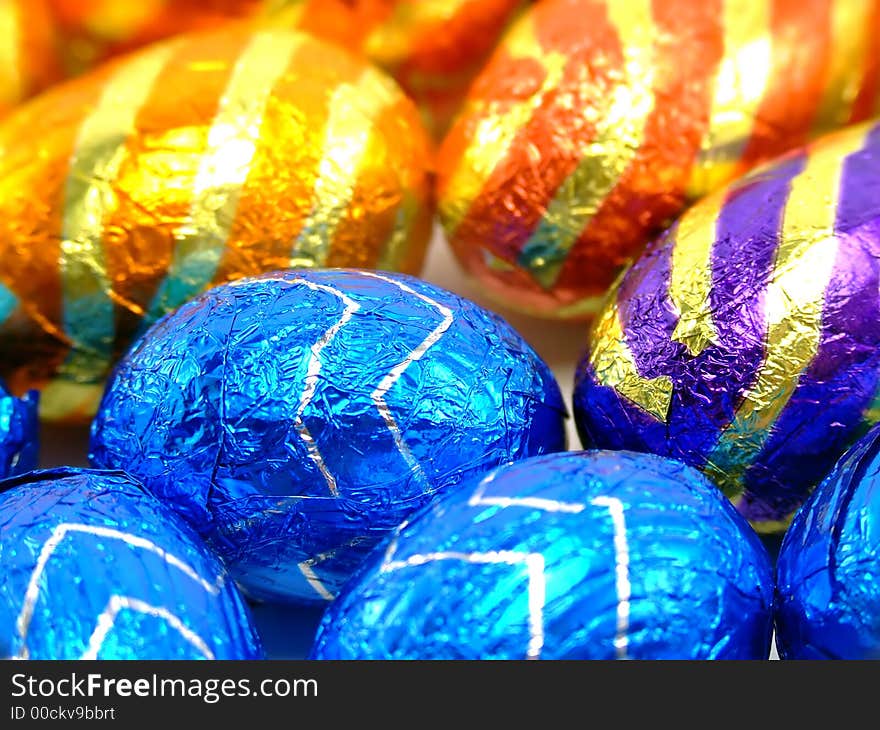 A macro shot of differend chocolate easter eggs in colorful wrapping. Can be used as background. A macro shot of differend chocolate easter eggs in colorful wrapping. Can be used as background