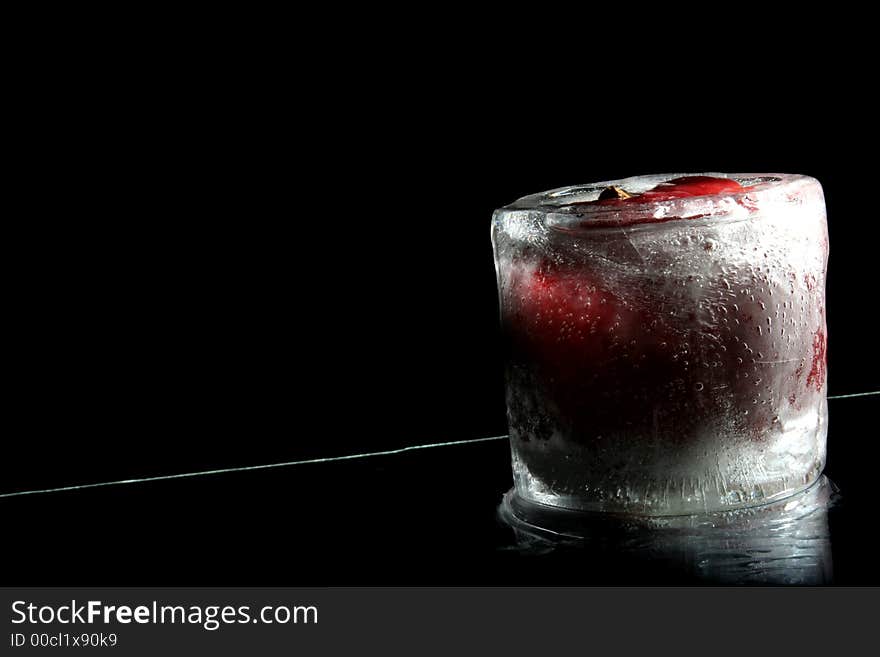 Apple covered with ice standing on black background. Apple covered with ice standing on black background