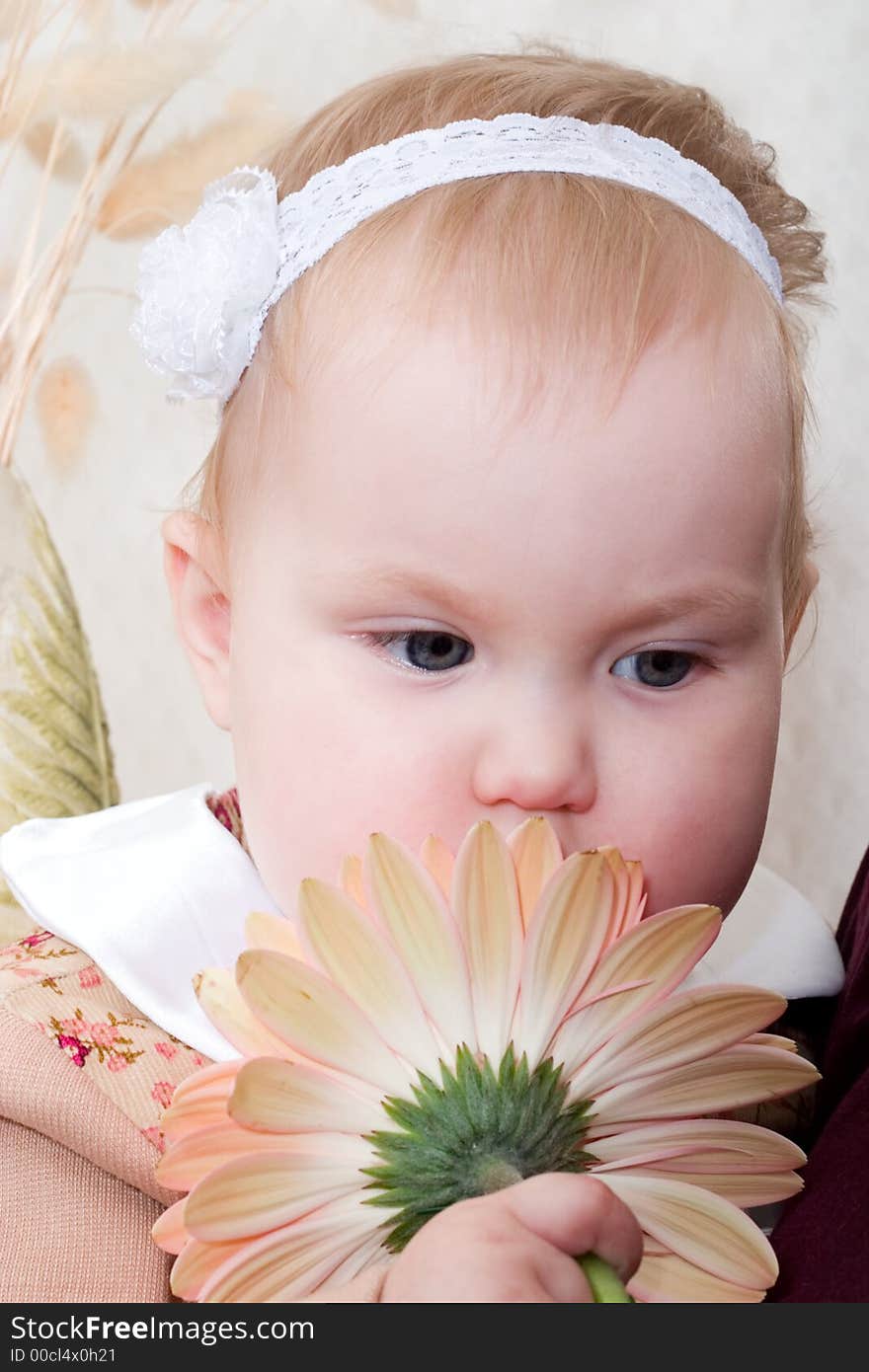 Portrait of thoughtful cute little girl with flower