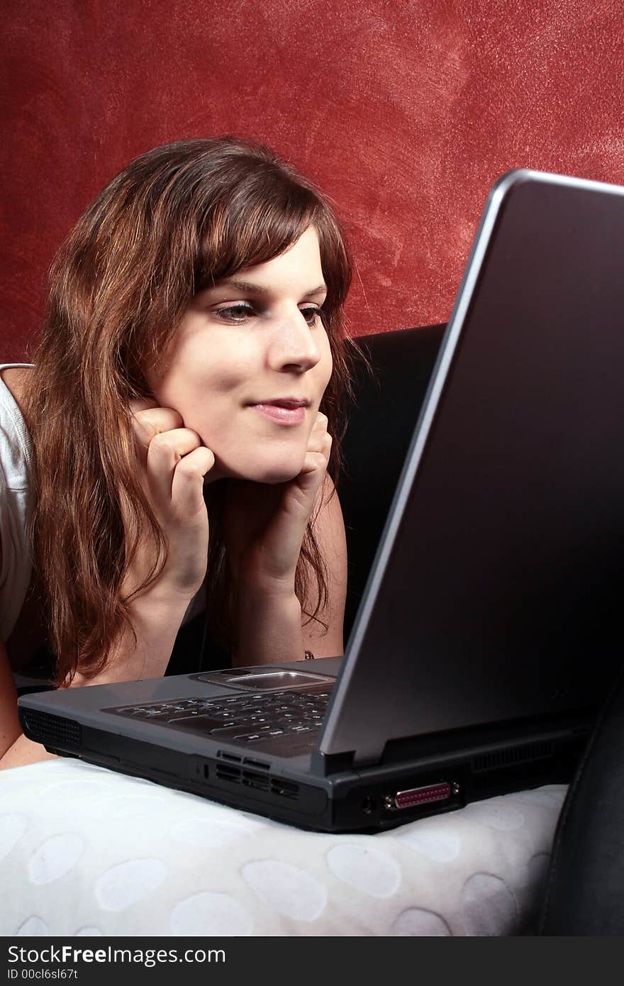 A woman is chatting with her laptop on the couch!. A woman is chatting with her laptop on the couch!